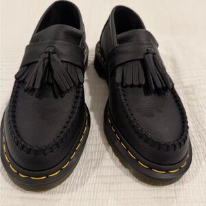 Black leather Dr. Martens tassel loafers